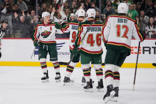 Minnesota Wild left wing Kirill Kaprizov left, celebrates with teammates after scoring a goal during the first period of an NHL hockey game against the Nashville Predators Tuesday, Nov. 4, 2025, in St. Paul, Minn. (AP Photo/Abbie Parr)