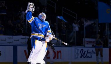 St. Louis Blues head coach Jim Montgomery, center, watches play against the Chicago Blackhawks during the third period in the Winter Classic at Wrigley Field.