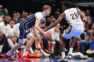 Dallas Mavericks forward Cooper Flagg, left, dribbles against New Orleans Pelicans center...