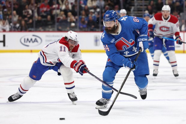 Brent Burns #84 of the Colorado Avalanche advances the puck against Brendan Gallagher #14 of the Montreal Canadiens in the first period at Ball Arena on November 29, 2025 in Denver, Colorado. (Photo by Matthew Stockman/Getty Images)
