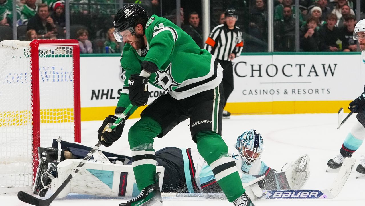 Dallas Stars center Tyler Seguin, top, prepares to score a goal on Seattle Kraken goaltender Matt Murray, bottom, during the first period of an NHL hockey game Sunday, Nov. 9, 2025, in Dallas. (AP Photo/Julio Cortez)