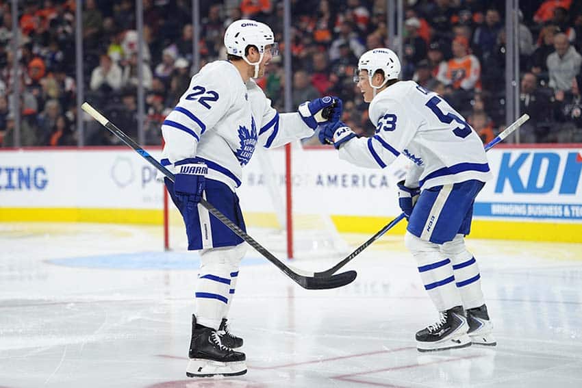 Nov 1, 2025; Philadelphia, Pennsylvania, USA; Toronto Maple Leafs defenseman Jake McCabe (22) celebrates a goal by right wing Easton Cowan (53) against the Philadelphia Flyers in the third period at Xfinity Mobile Arena.
