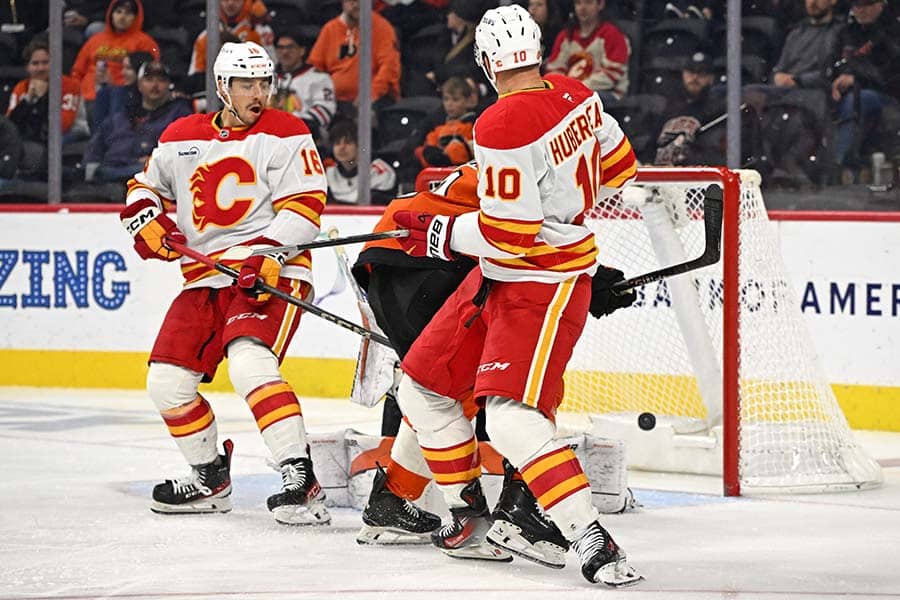 Nov 2, 2025; Philadelphia, Pennsylvania, USA; Calgary Flames left wing Jonathan Huberdeau (10) deflects the puck for a goal against the Philadelphia Flyers during the third period at Xfinity Mobile Arena.