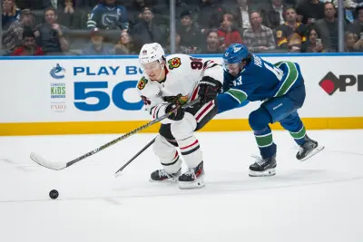 Nov 5, 2025; Vancouver, British Columbia, CAN; Vancouver Canucks defenseman Quinn Hughes (43) stick checks Chicago Blackhawks forward Connor Bedard (98) in the third period at Rogers Arena. Mandatory Credit: Bob Frid-Imagn Images
