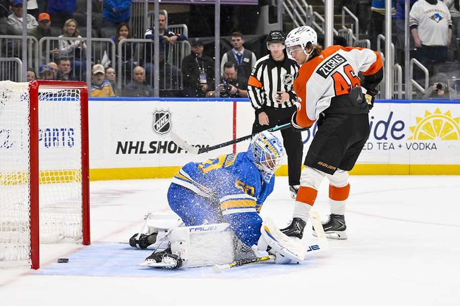 Nov 14, 2025; St. Louis, Missouri, USA; Philadelphia Flyers center Trevor Zegras (46) scores against St. Louis Blues goaltender Jordan Binnington (50) in shootouts at Enterprise Center.