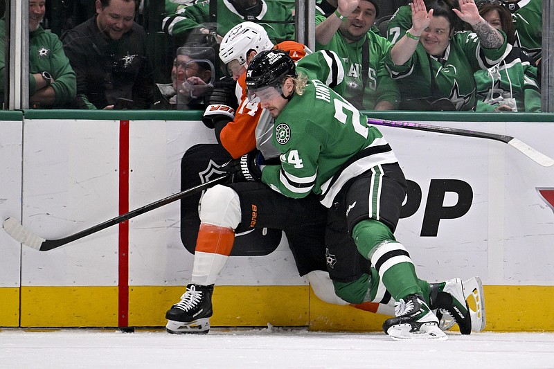Nov 15, 2025; Dallas, Texas, USA; Philadelphia Flyers center Sean Couturier (14) and Dallas Stars center Roope Hintz (24) battle for control of the puck during the first period at the American Airlines Center. Mandatory Credit: Jerome Miron-Imagn Images