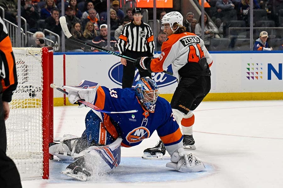 Nov 28, 2025; Elmont, New York, USA; Philadelphia Flyers center Trevor Zegras (46) scores a goal past New York Islanders goaltender David Rittich (33) during shootouts period at UBS Arena.