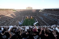 The Texas A&M football team enters Kyle Field as fans cheer them on before the start of an...