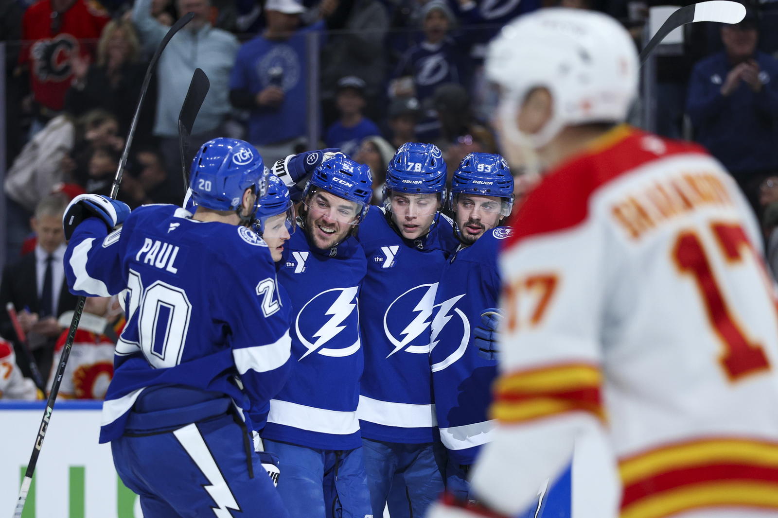 Tampa Bay Lightning left wing Nick Paul (20), defenceman Charle-Edouard D'Astous (51), defenceman Emil Lilleberg (78) and centre Gage Goncalves (93) react after a goal against the Calgary Flames in their game at Benchmark International Arena in Tampa, Florida (Source: Nathan Ray Seebeck-Imagn Images)