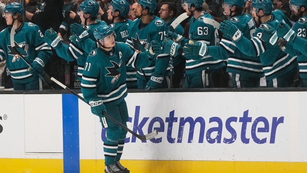 San Jose Sharks center Macklin Celebrini (71) is congratulated by teammates after scoring against the Boston Bruins during the second period of an NHL hockey game in San Jose, Calif., Sunday, Nov. 23, 2025. (AP Photo/Jeff Chiu)