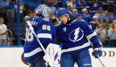 Tampa Bay Lightning goaltender Andrei Vasilevskiy (88) celebrates with defenseman Steven Santini after the team defeated the Calgary Flames during an NHL hockey game Wednesday, Nov. 26, 2025, in Tampa, Fla. (AP Photo/Chris O'Meara)