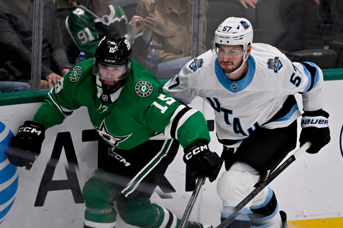 Apr 12, 2025; Dallas, Texas, USA; Dallas Stars center Colin Blackwell (15) and Utah Hockey Club defenseman Nick DeSimone (57) chase the puck during the third period at the American Airlines Center. Mandatory Credit: Jerome Miron-Imagn Images