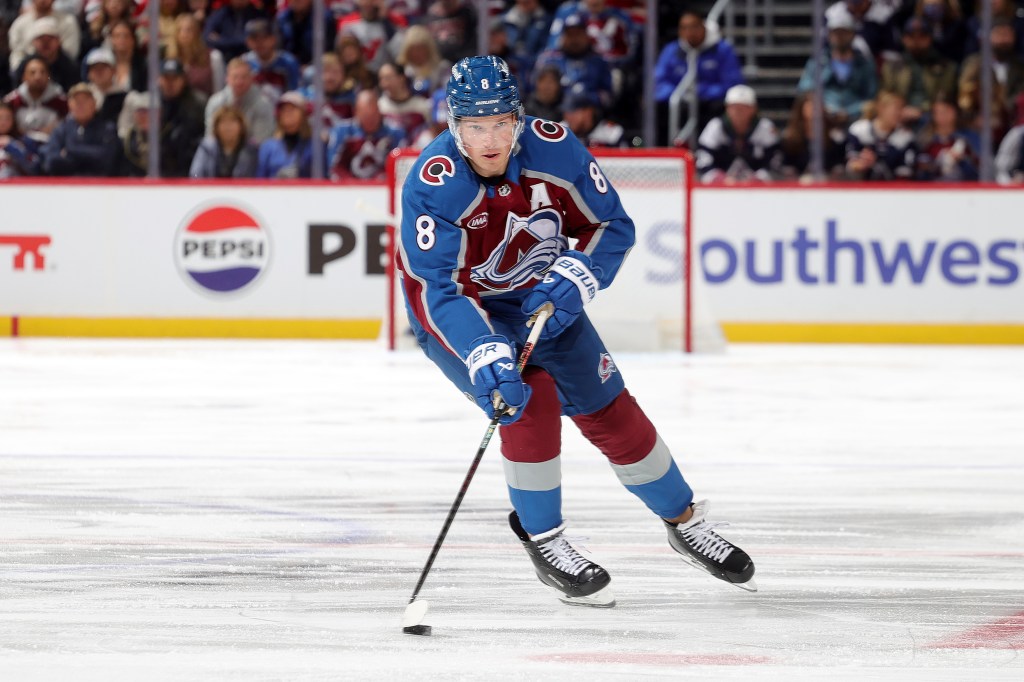 Cale Makar of the Colorado Avalanche skates with the puck on the ice.
