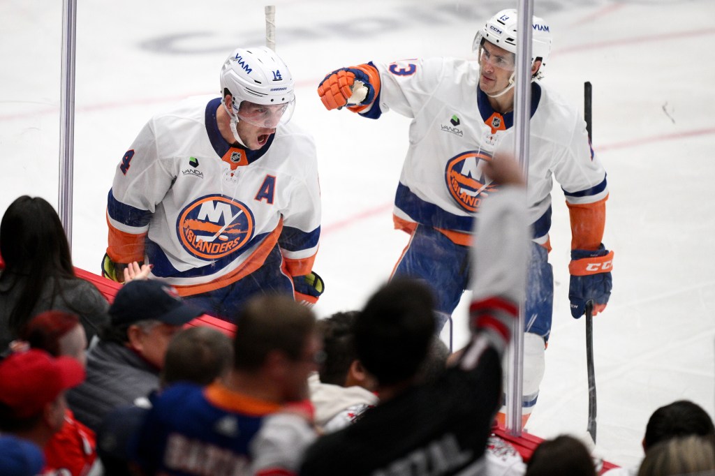 New York Islanders center Bo Horvat (14) celebrates his goal with center Mathew Barzal (13) during the third period of an NHL hockey game against the Washington Capitals, Friday, Oct. 31, 2025.