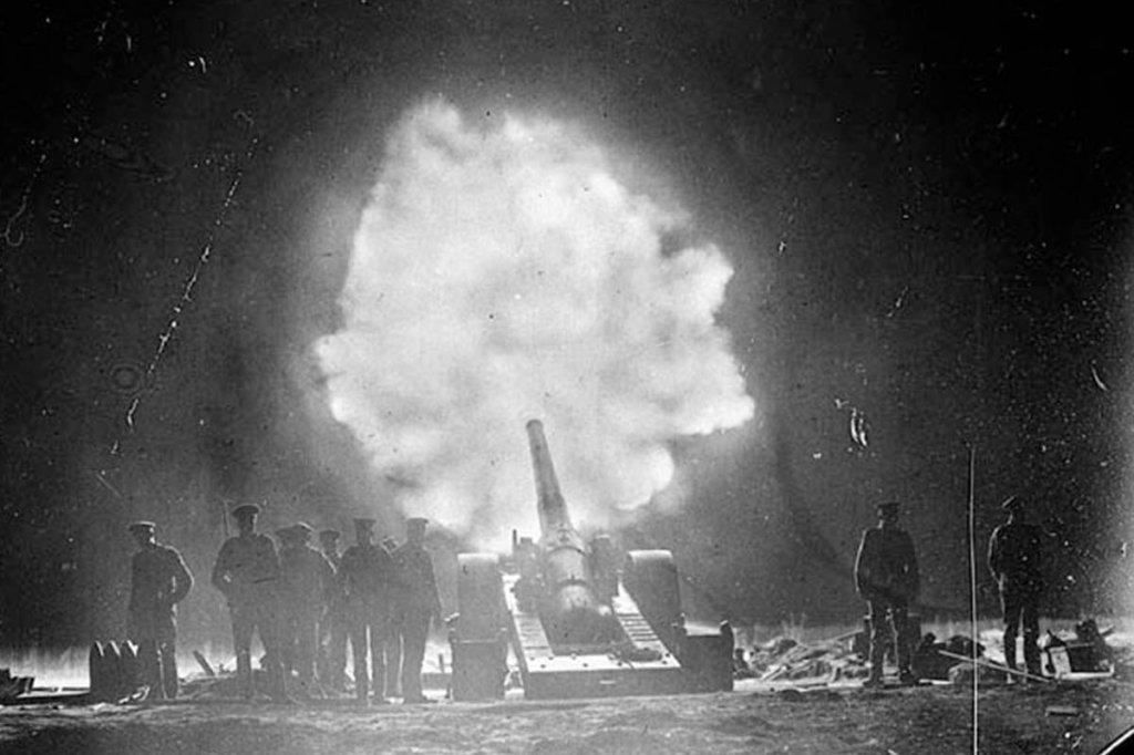 A 6-inch Naval gun on "Percy Scott" carriage, firing over Vimy Ridge behind Canadian lines at night, World War I. (Canada Dept. of National Defence)