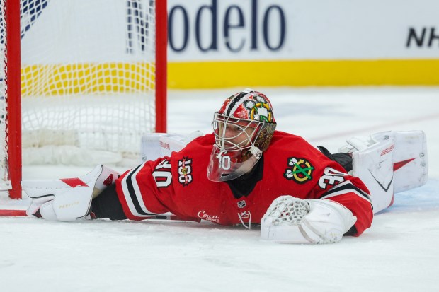 Chicago Blackhawks goaltender Spencer Knight (30) lays on the ice after Toronto Maple Leafs defenseman Morgan Rielly (44) scores a goal during the second period at the United Center Saturday Nov. 15, 2025 in Chicago. (Armando L. Sanchez/Chicago Tribune)