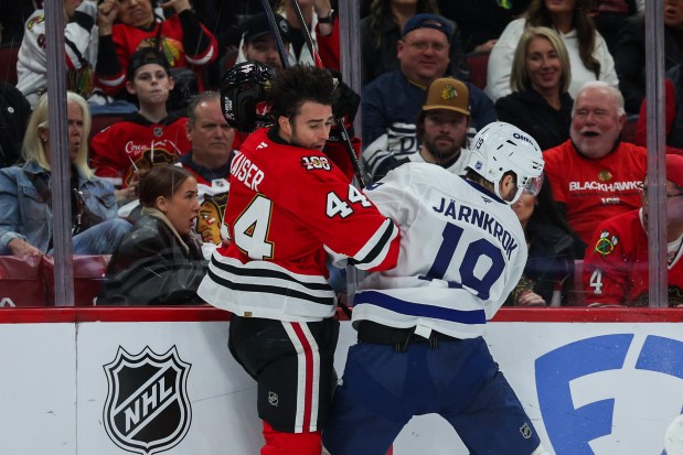 Toronto Maple Leafs center Calle Jarnkrok (19) knocks Chicago Blackhawks defenseman Wyatt Kaiser (44) helmet off during the second period at the United Center Saturday Nov. 15, 2025 in Chicago. (Armando L. Sanchez/Chicago Tribune)