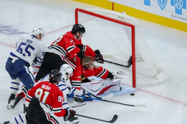 Chicago Blackhawks goaltender Spencer Knight (30) blocks the puck during the third period against the Toronto Maple Leafs at the United Center Saturday Nov. 15, 2025 in Chicago. (Armando L. Sanchez/Chicago Tribune)