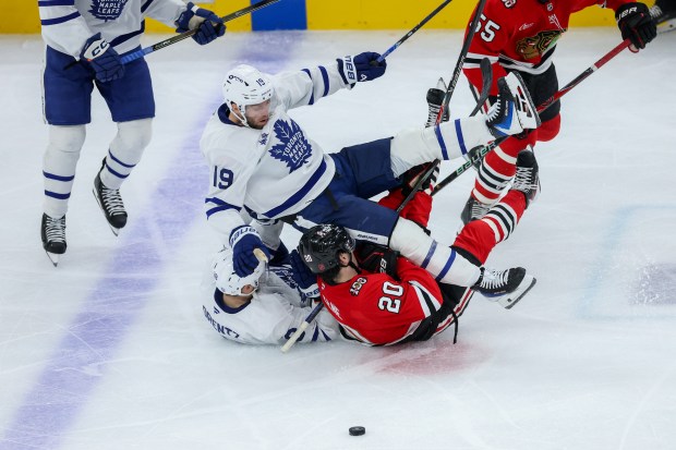 Toronto Maple Leafs center Calle Jarnkrok (19) falls on Chicago Blackhawks center Ryan Greene (20) during the third period at the United Center Saturday Nov. 15, 2025 in Chicago. (Armando L. Sanchez/Chicago Tribune)