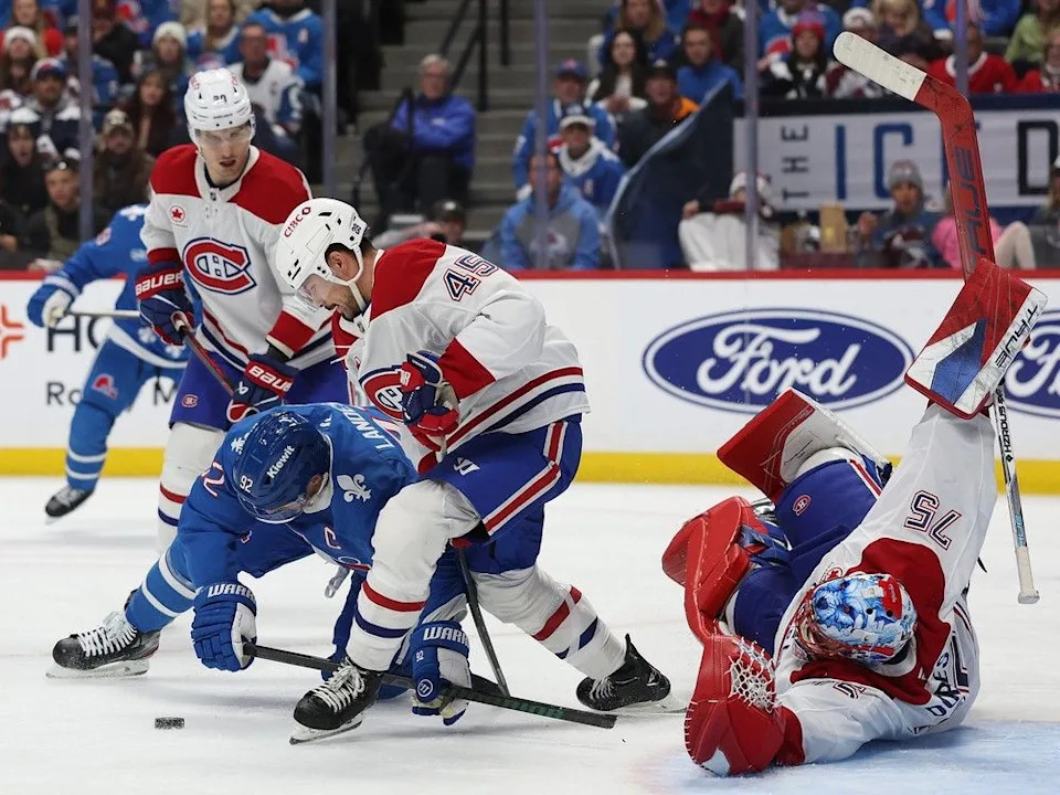  Gabriel Landeskog (92) of the Colorado Avalanche fights for the puck against Canadiens’ Alexandre Carrier as Montreal goaltender Jakub Dobes sprawls on the ice on Saturday, Nov. 29, 2025, in Denver.
