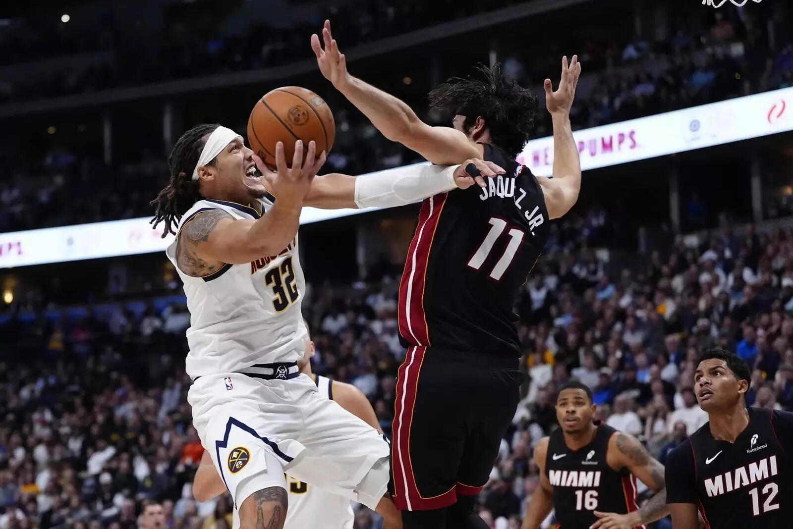 Denver Nuggets forward Aaron Gordon (32) shoots the ball at Miami Heat forward Jaime Jaquez Jr. (11) (Image via Imagn) Denver Nuggets forward Aaron Gordon (32) shoots the ball at Miami Heat forward Jaime Jaquez Jr. (11)