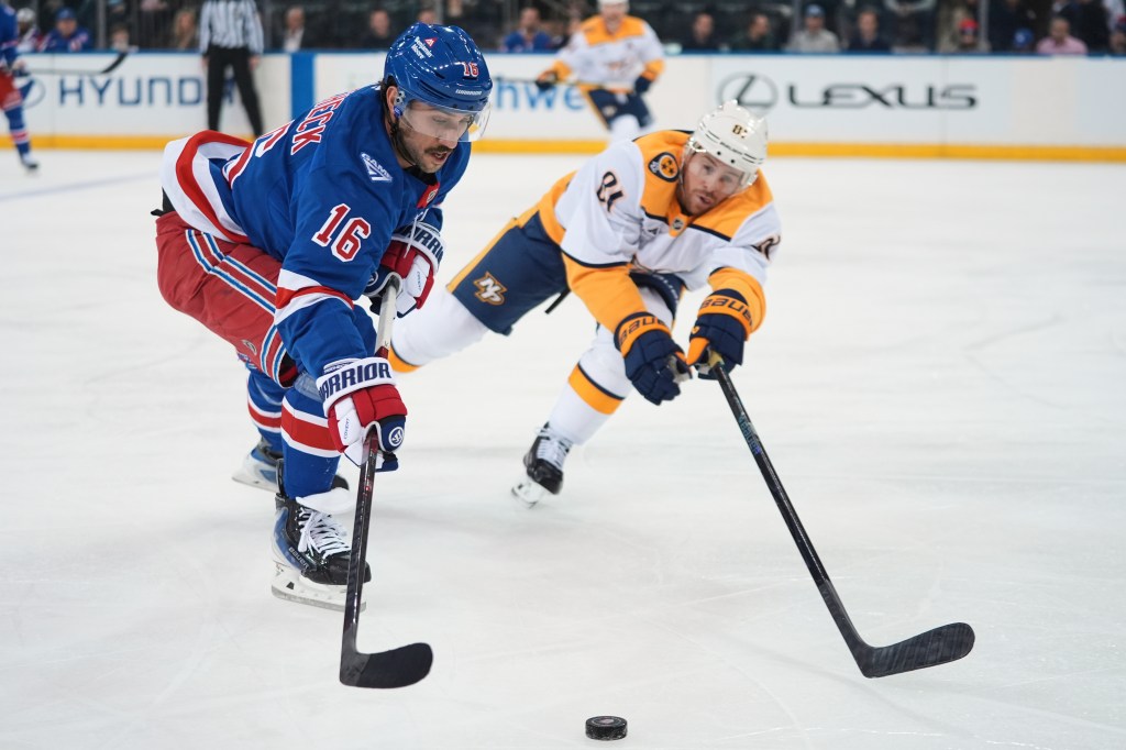 New York Rangers' Vincent Trocheck (16) drives past Nashville Predators' Jonathan Marchessault (81) during the first period of an NHL hockey game.