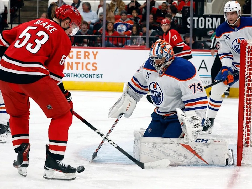 Carolina Hurricanes’ Jackson Blake (53) tries to gather in the puck in front of Edmonton Oilers goaltender Stuart Skinner (74) during the second period of an NHL hockey game in Raleigh, N.C., Saturday, Nov. 15, 2025.