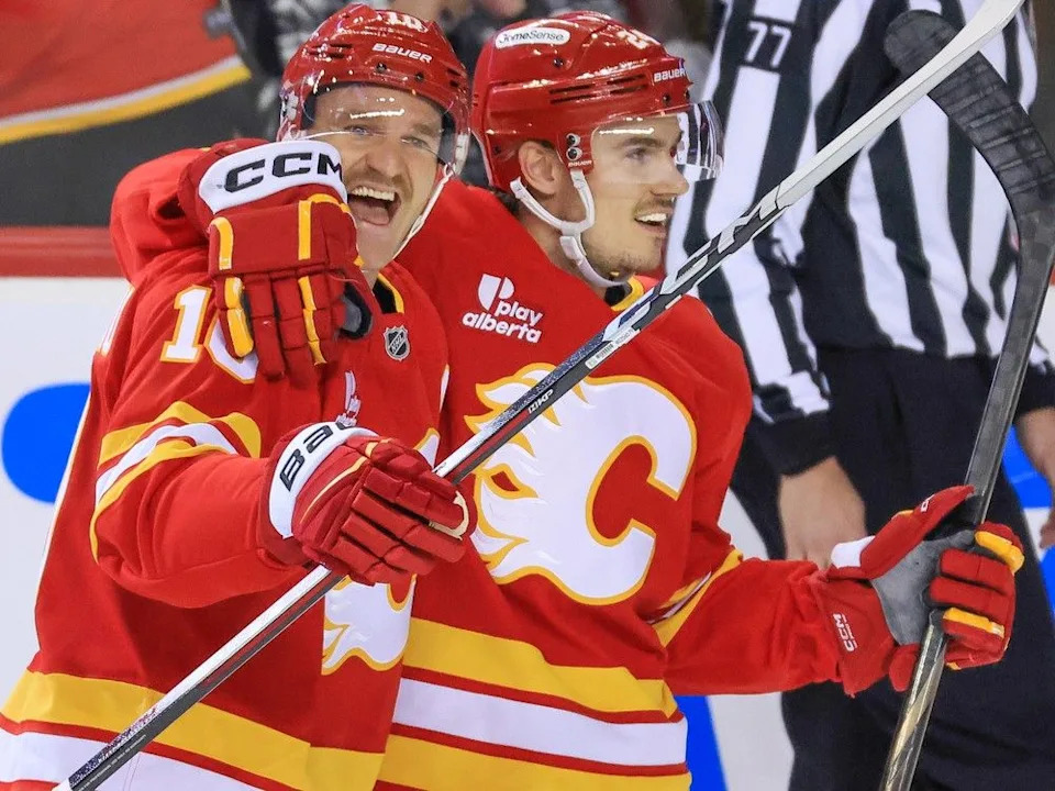  Calgary Flames forward Jonathan Huberdeau, left and defenceman Jake Bean celebrate Bean’s goal on Winnipeg Jets goalie Connor Hellebuyck during NHL action at the Scotiabank Saddledome in Calgary on November 15, 2025. It was Bean’s first goal of the season. Gavin Young/Postmedia