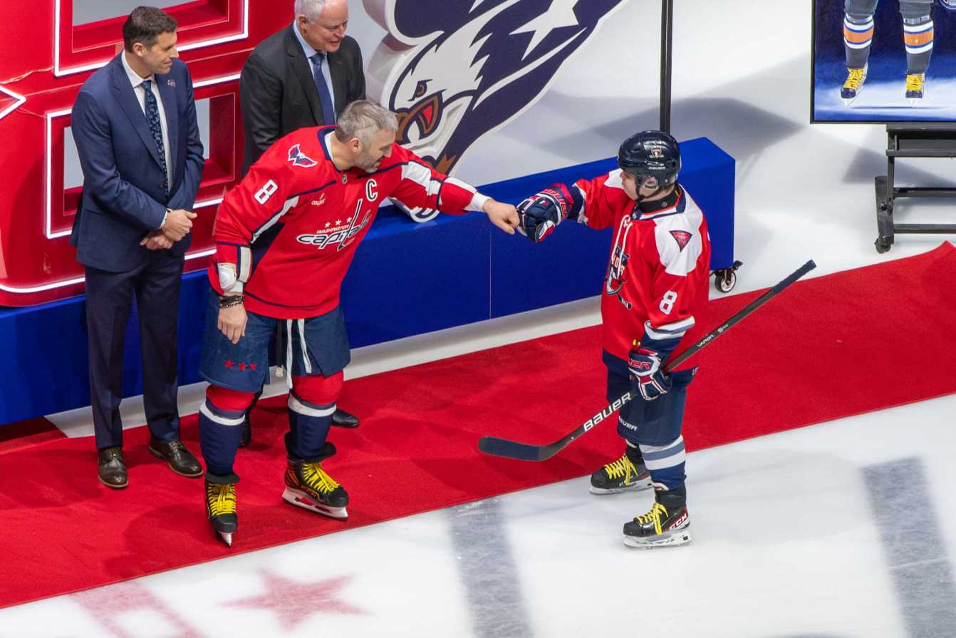 Alex Ovechkin gives a fist bump to a youth hockey player