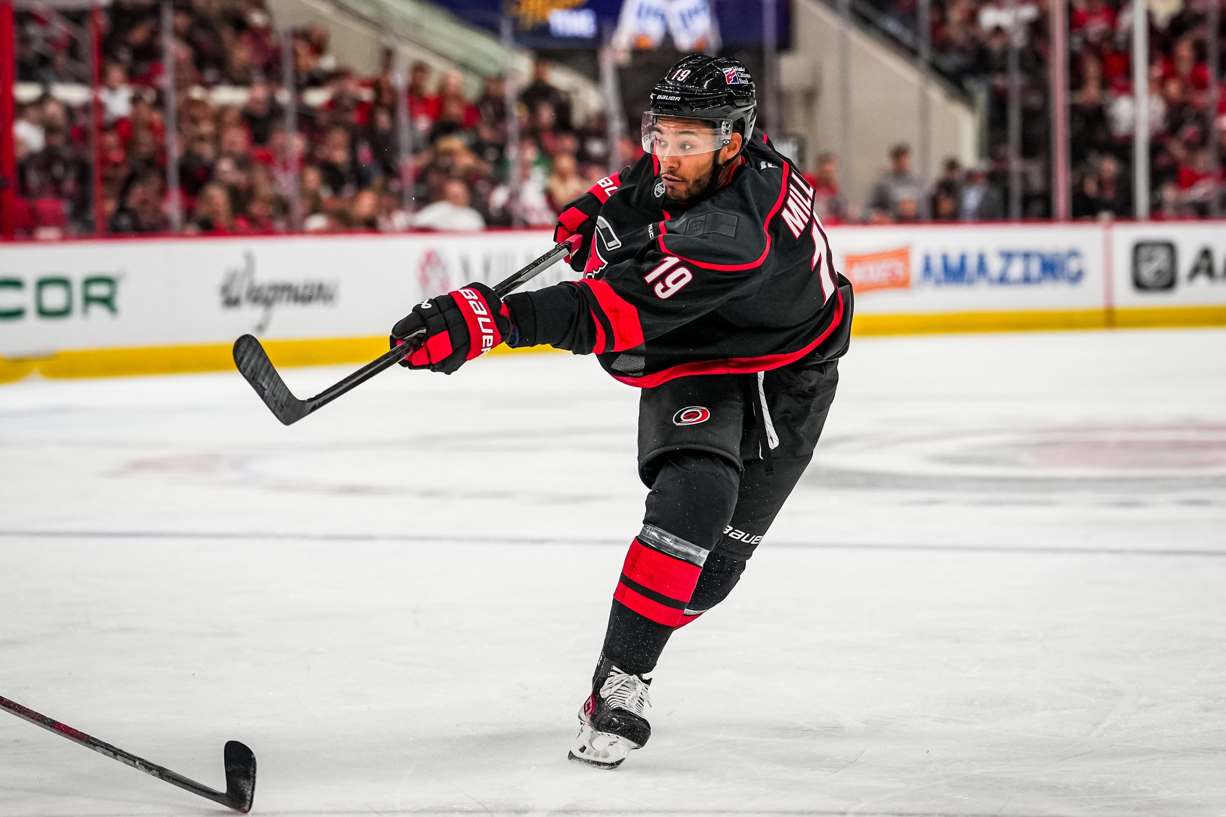 RALEIGH, NORTH CAROLINA - OCTOBER 09: K’Andre Miller #19 of the Carolina Hurricanes shoots the puck during the third period against the New Jersey Devils at Lenovo Center on October 09, 2025 in Raleigh, North Carolina. (Photo by Josh Lavallee/NHLI via Getty Images)