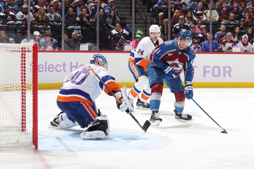 New York Islanders goalie Ilya Sorokin defends against Colorado Avalanche player Brock Nelson.