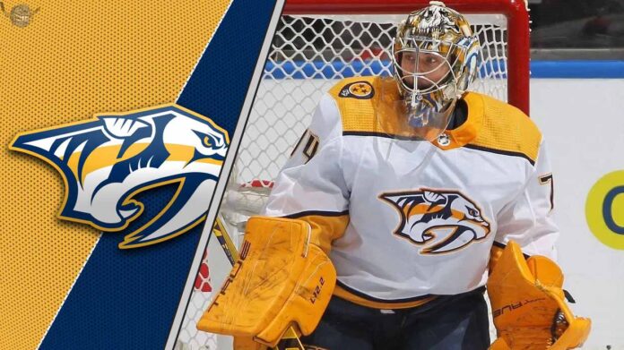 Nashville Predators goalie Juuse Saros looks on intently during a game, his future with the struggling team in question amid NHL trade rumors.