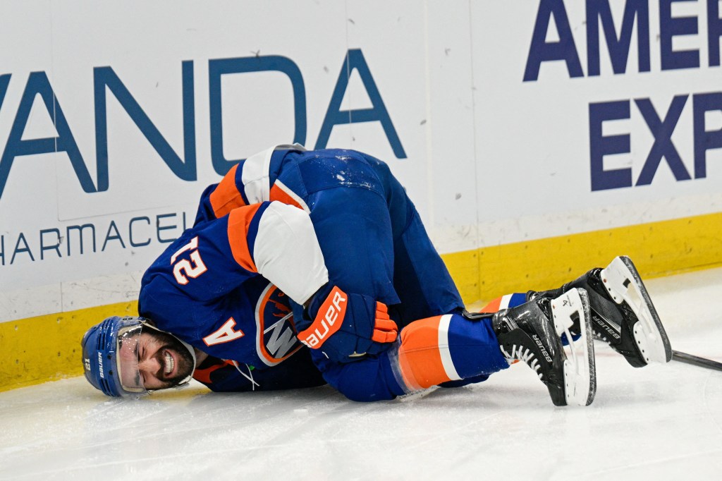 New York Islanders center Kyle Palmieri (21) falls to the ice after an injury.