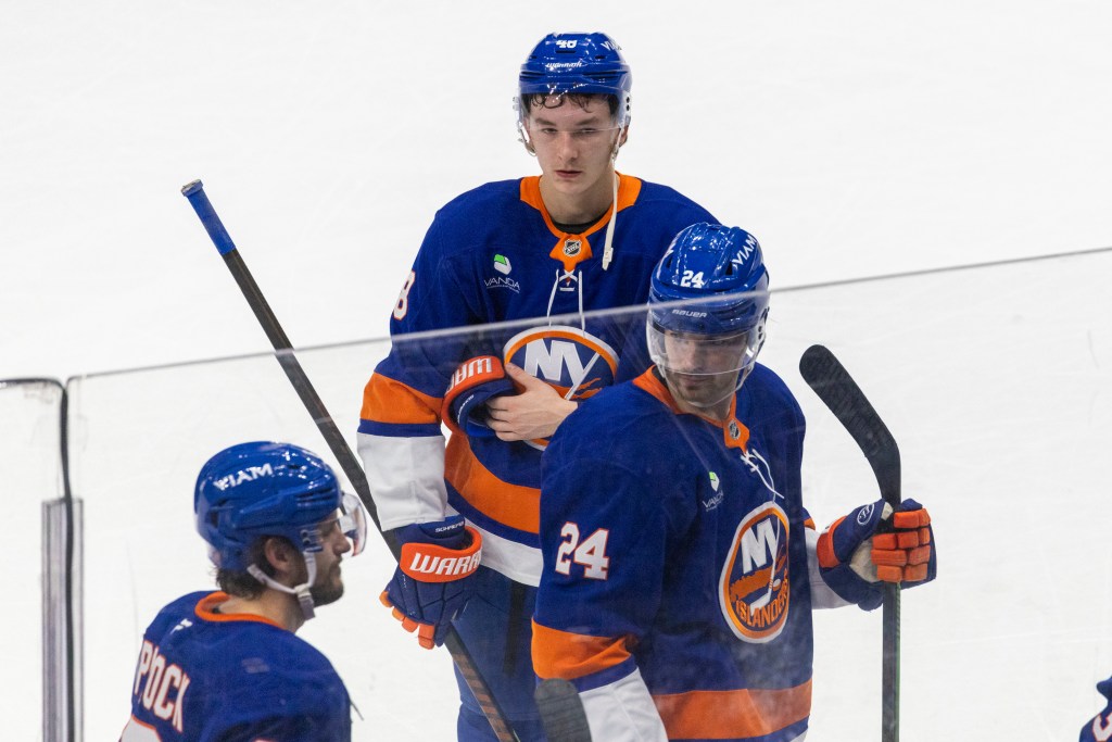 New York Islanders players reacting after a shootout loss.