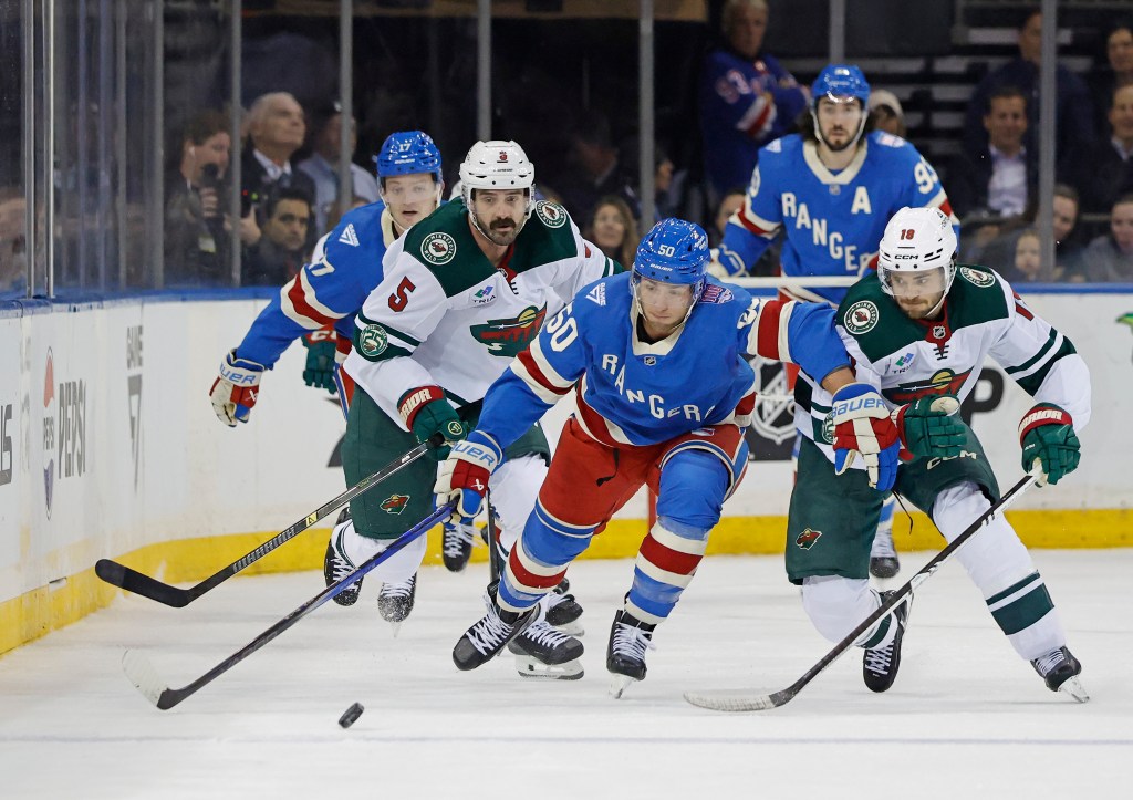 Rangers left wing Will Cuylle passes the puck as Minnesota Wild center Vinnie Hinostroza tries to steal it in the first period at Madison Square Garden in New York, October 20, 2025.