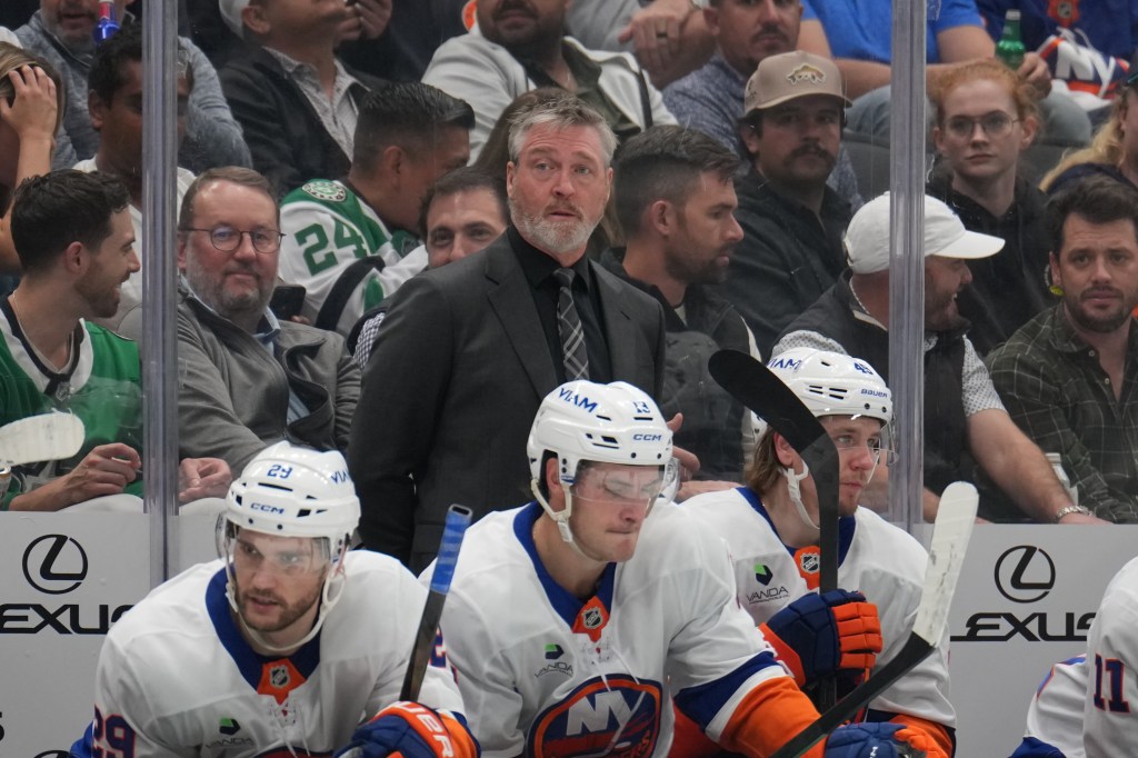 New York Islanders coach Patrick Roy watches the game from behind the bench.