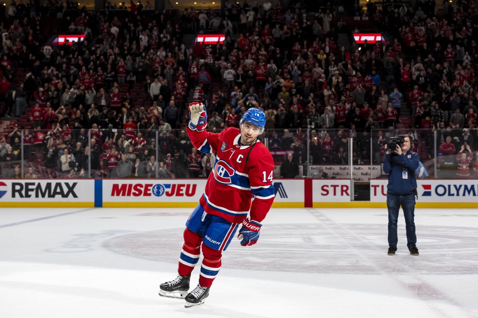 \u200bNick Suzuki waving to fans in the Montreal Canadiens kit on the ice