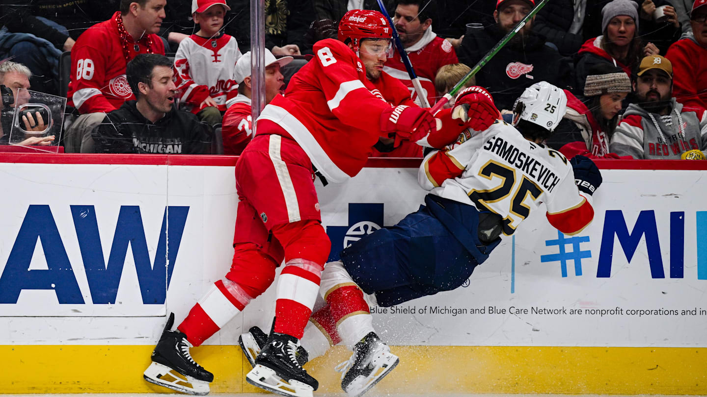 Apr 6, 2025; Detroit, Michigan, USA; Detroit Red Wings defenseman Ben Chiarot (8) checks Florida Panthers right wing Mackie Samoskevich (25) during the third period at Little Caesars Arena. Mandatory Credit: Tim Fuller-Imagn Images