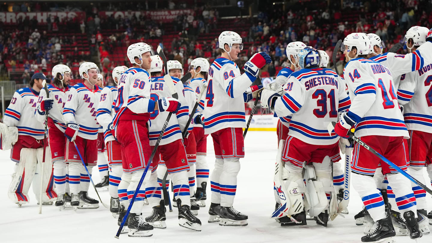 Nov 26, 2025; Raleigh, North Carolina, USA; New York Rangers players celebrate the win against the Carolina Hurricanes at Lenovo Center. Mandatory Credit: James Guillory-Imagn Images
