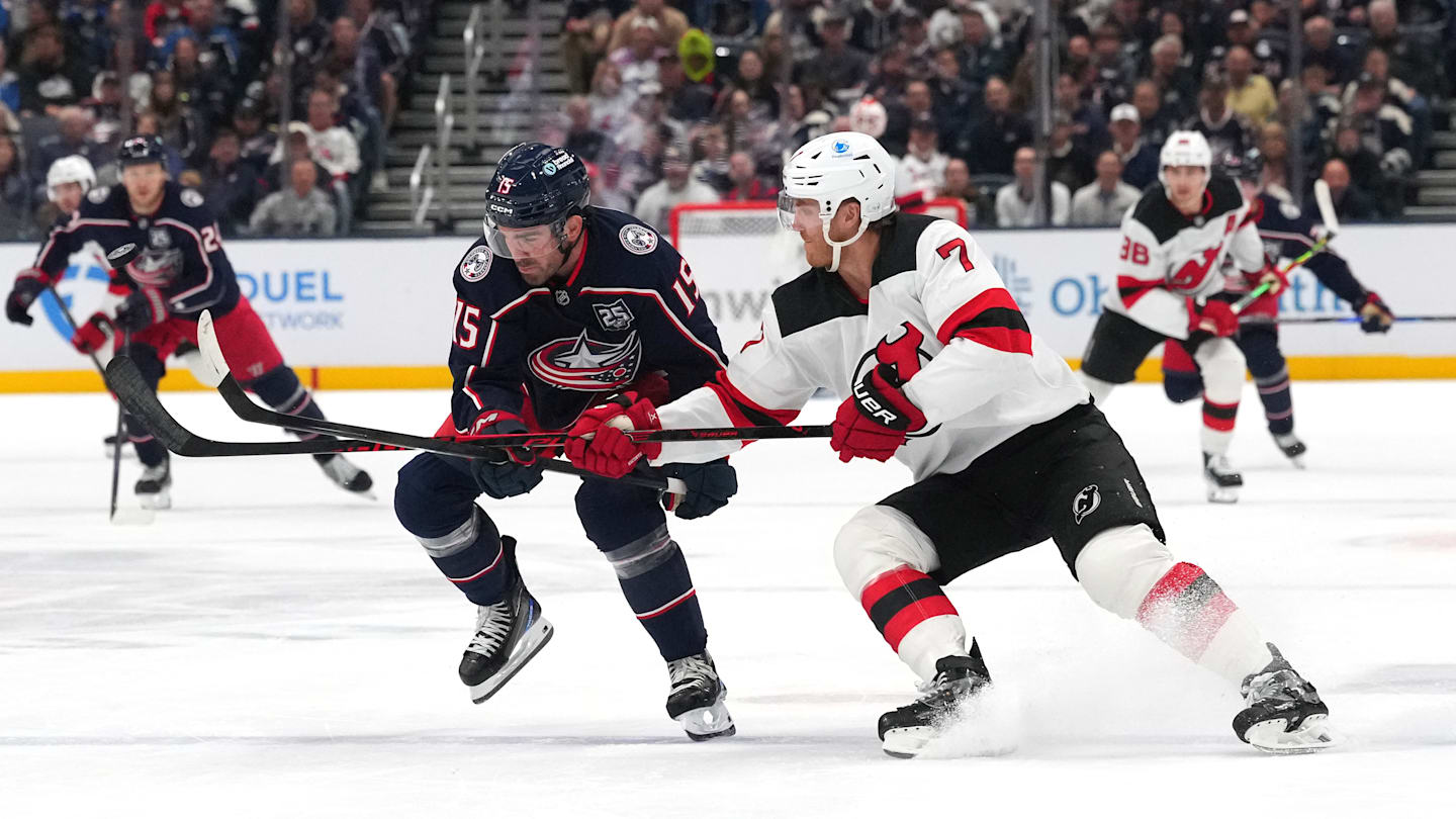 Blue Jackets defenseman Dante Fabbro competes with Devils defenseman Dougie Hamilton.