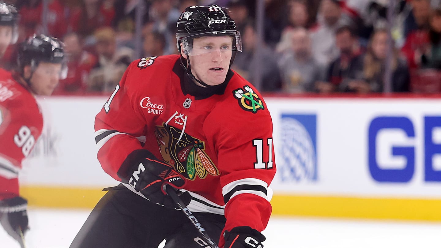 Nov 9, 2025; Detroit, Michigan, USA; Chicago Blackhawks center Oliver Moore (11) takes a shot on Detroit Red Wings goaltender John Gibson (36) (not pictured) during the first period at Little Caesars Arena. Mandatory Credit: Brian Bradshaw Sevald-Imagn Images