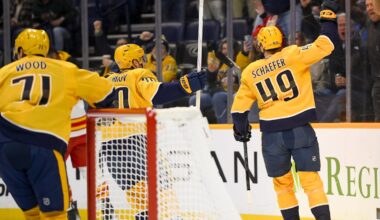 Dec 2, 2025; Nashville, Tennessee, USA;  Nashville Predators left wing Reid Schaefer (49) celebrates his goal against the Calgary Flames during the first period at Bridgestone Arena. Mandatory Credit: Steve Roberts-Imagn Images