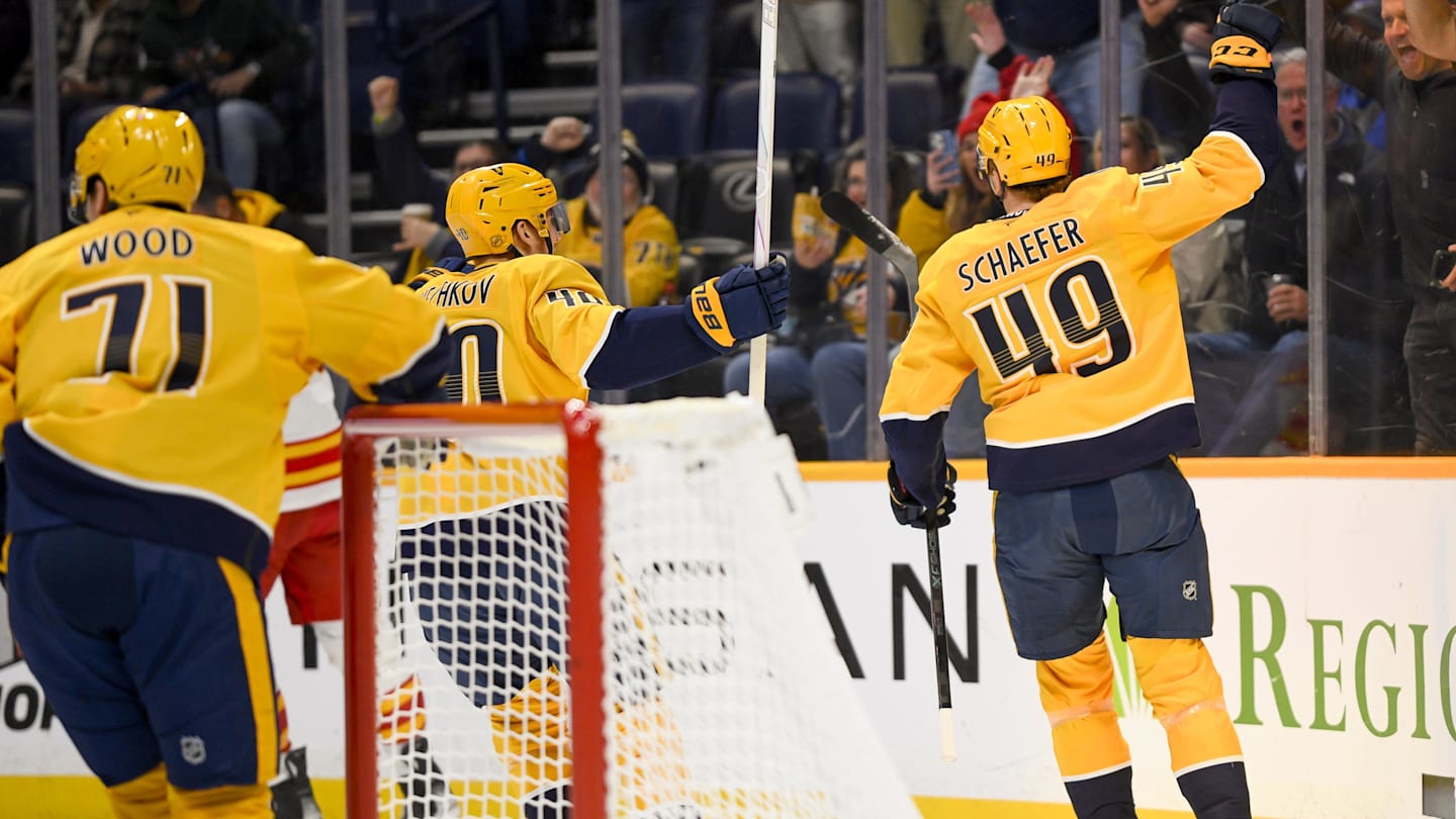 Dec 2, 2025; Nashville, Tennessee, USA;  Nashville Predators left wing Reid Schaefer (49) celebrates his goal against the Calgary Flames during the first period at Bridgestone Arena. Mandatory Credit: Steve Roberts-Imagn Images