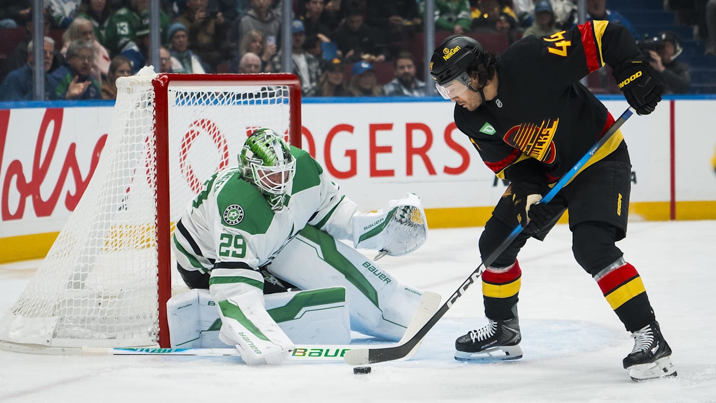 Nov 20, 2025; Vancouver, British Columbia, CAN; Dallas Stars goalie Jake Oettinger (29) makes a save on Vancouver Canucks forward Kiefer Sherwood (44) in the second period at Rogers Arena. Mandatory Credit: Bob Frid-Imagn Images