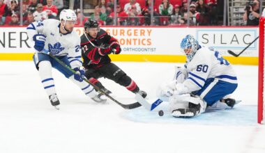 Dec 4, 2025; Raleigh, North Carolina, USA; Toronto Maple Leafs goaltender Joseph Woll (60) with center Scott Laughton (24) stops the scoring attempt by Carolina Hurricanes center Logan Stankoven (22) during the first period at Lenovo Center. Mandatory Credit: James Guillory-Imagn Images