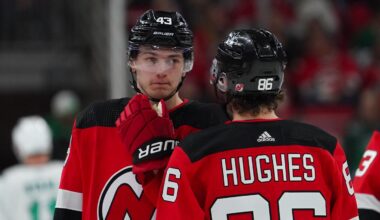 Feb 10, 2024; Raleigh, North Carolina, USA; New Jersey Devils center Jack Hughes (86) and defenseman Luke Hughes (43) talk against the Carolina Hurricanes during the first period at PNC Arena. Mandatory Credit: James Guillory-Imagn Images