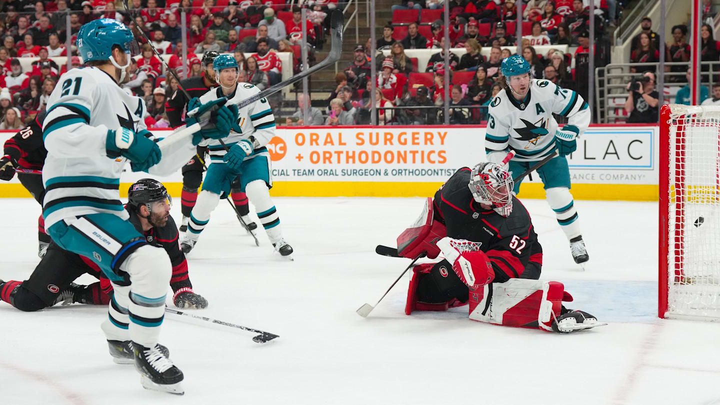 Dec 7, 2025; Raleigh, North Carolina, USA;  San Jose Sharks center Alexander Wennberg (21) scores a goal past Carolina Hurricanes goaltender Pyotr Kochetkov (52) during the second period at Lenovo Center. Mandatory Credit: James Guillory-Imagn Images
