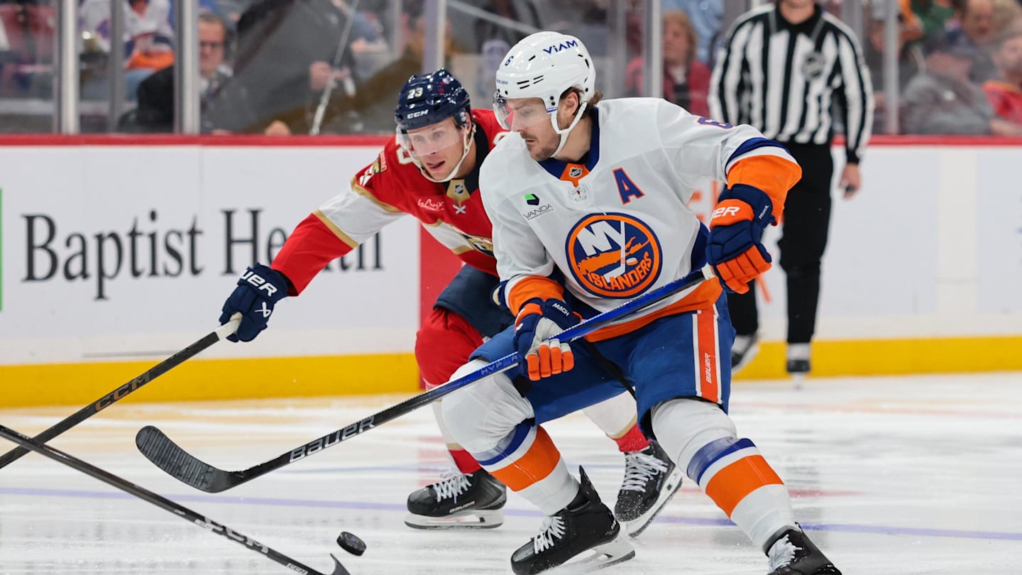 Dec 7, 2025; Sunrise, Florida, USA; New York Islanders defenseman Ryan Pulock (6) moves the puck against Florida Panthers center Carter Verhaeghe (23) during the third period at Amerant Bank Arena. Mandatory Credit: Sam Navarro-Imagn Images
