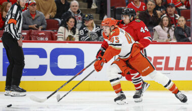 Oct 19, 2025; Chicago, Illinois, USA; Chicago Blackhawks defenseman Wyatt Kaiser (44) defends against Anaheim Ducks right wing Beckett Sennecke (45) during the first period at United Center. Mandatory Credit: Kamil Krzaczynski-Imagn Images