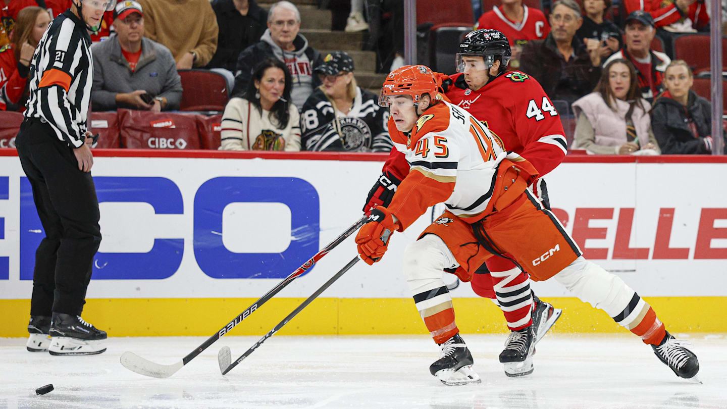 Oct 19, 2025; Chicago, Illinois, USA; Chicago Blackhawks defenseman Wyatt Kaiser (44) defends against Anaheim Ducks right wing Beckett Sennecke (45) during the first period at United Center. Mandatory Credit: Kamil Krzaczynski-Imagn Images